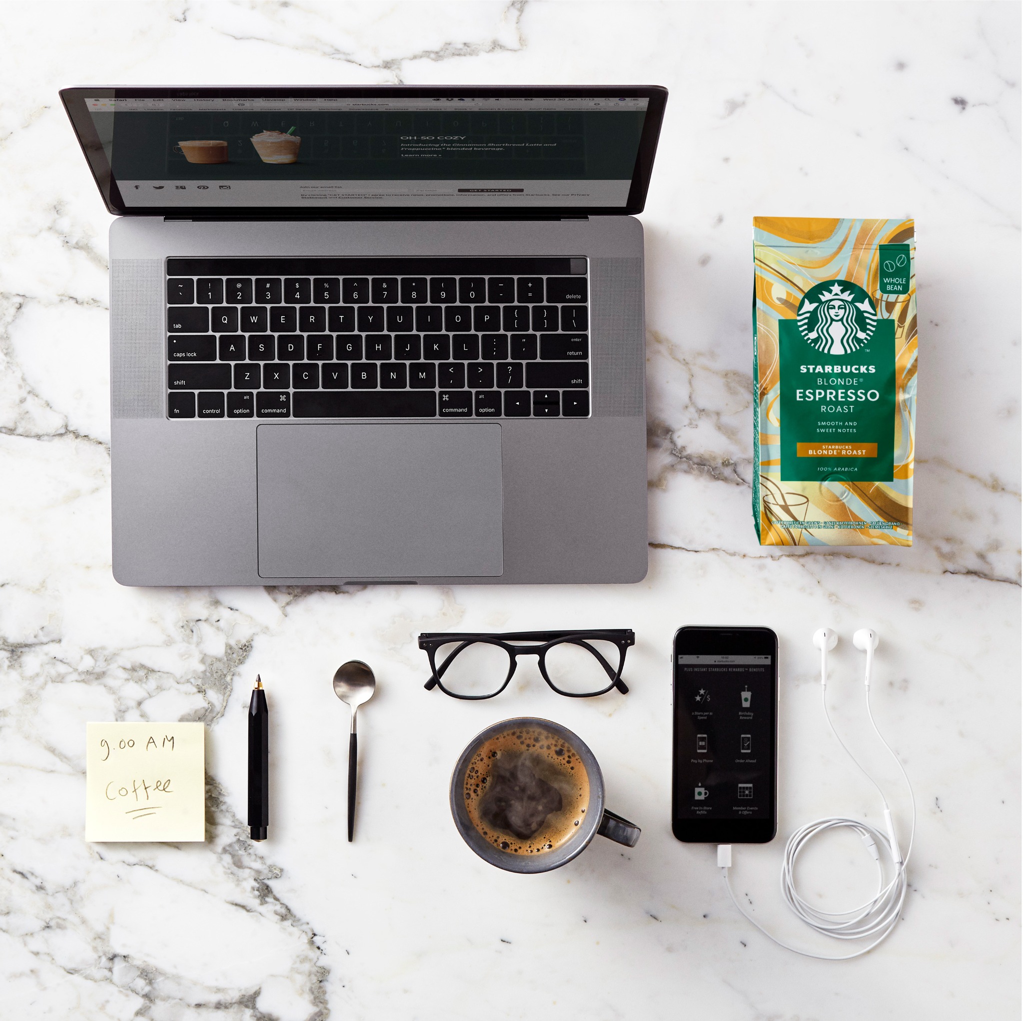 Starbucks product lifestyle composition with laptop and coffee packaging